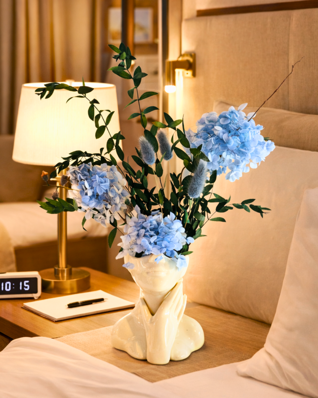 Decorative vase with blue preserved flowers on a nightstand next to a lamp | Fleur Reverie | Austin TX