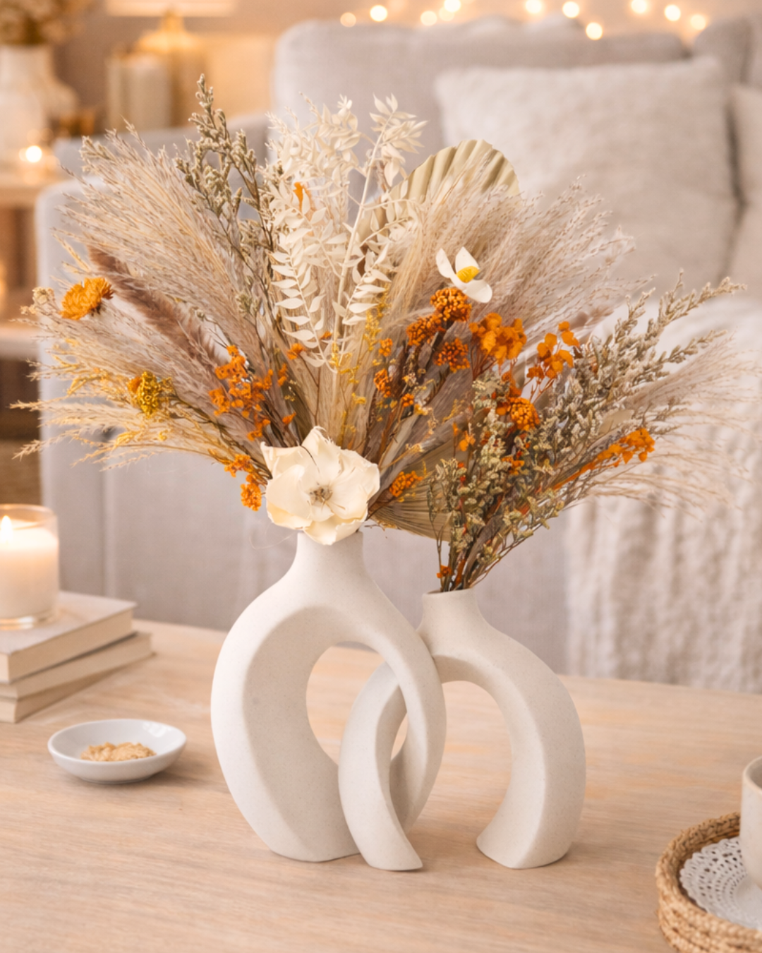 Decorative vase with dried flowers on a table in a cozy living room setting | Fleur Reverie