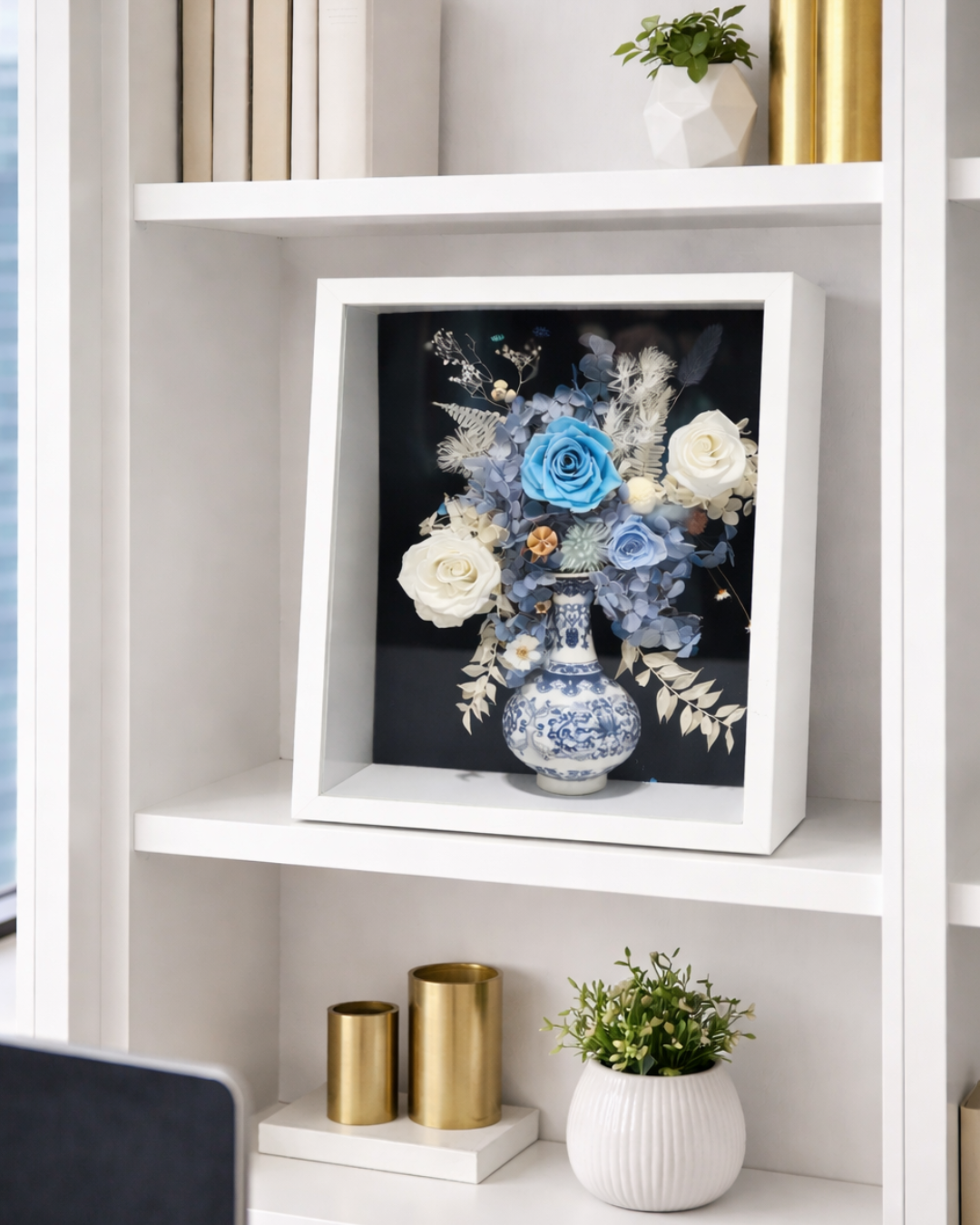 Decorative arrangement of preserved flowers and a vase in a white frame on a shelf | Fleur Reverie