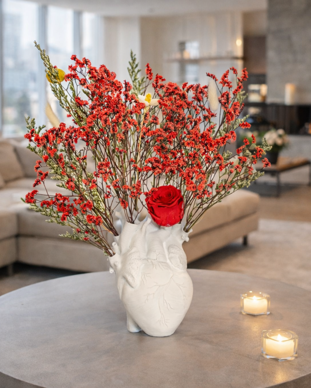 White vase with red dried flowers on a table in a living room | Fleur Reverie | Austin TX