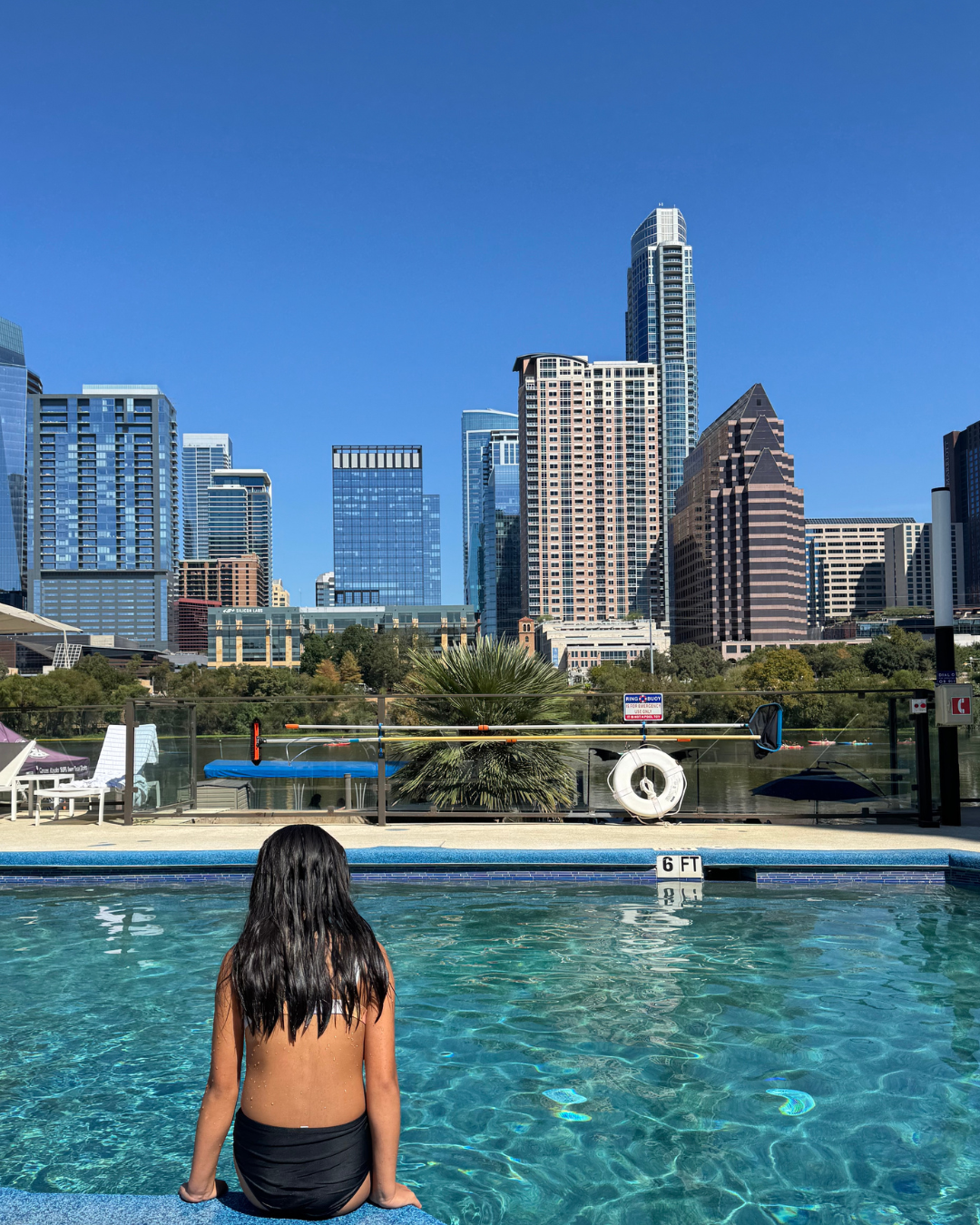 Sitting on a pool of Austin Hyatt Regency Hotel to overlook Austin Texas Skyline