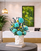 Decorative vase with blue preserved flowers on a table in a modern interior setting | Fleur Reverie | Austin TX