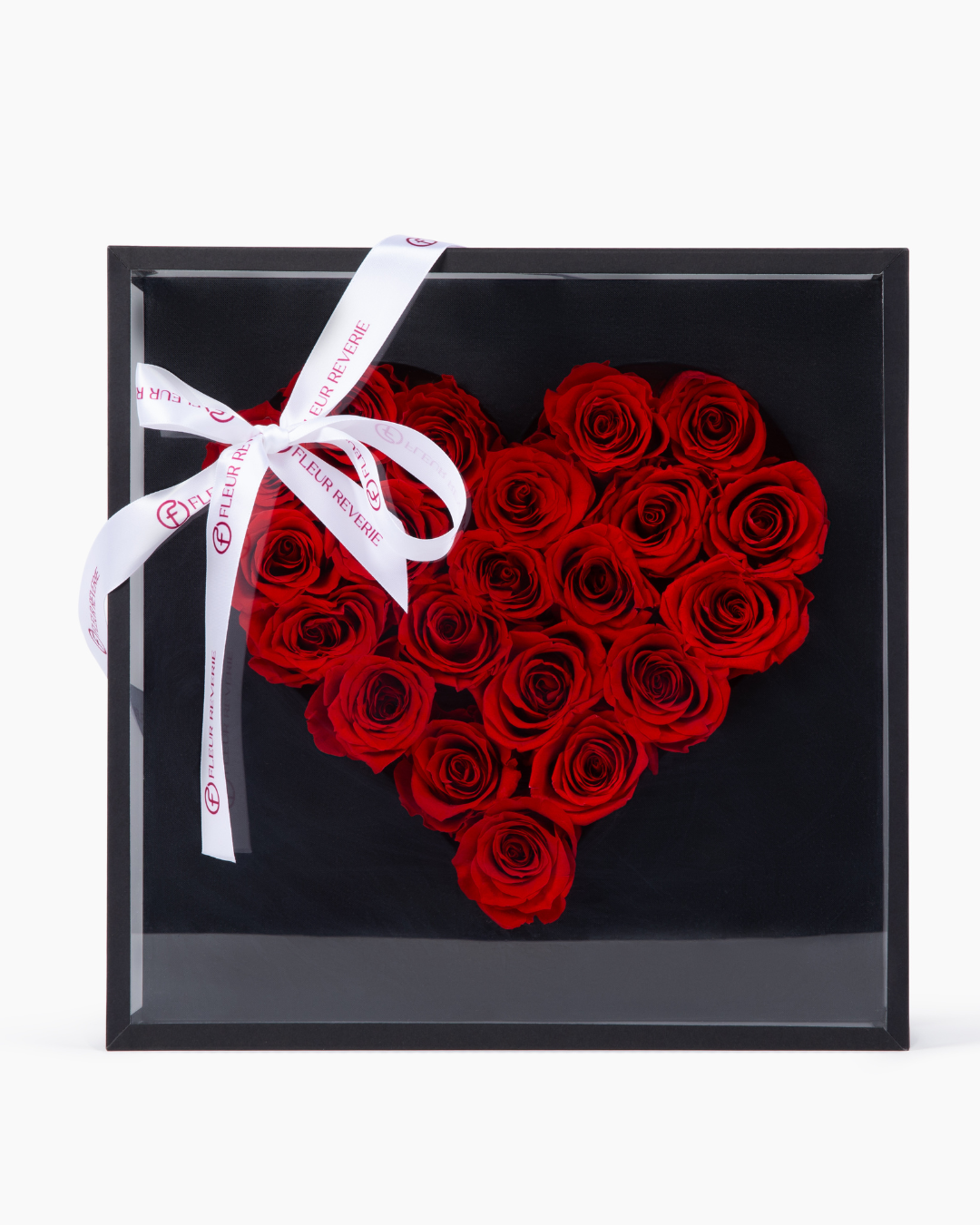 Heart-shaped arrangement of preserved red roses in a black box with a white ribbon | Fleur Reverie
