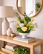 Preserved Floral arrangement on a wooden console table with books and a lamp | Fleur Reverie | Austin TX