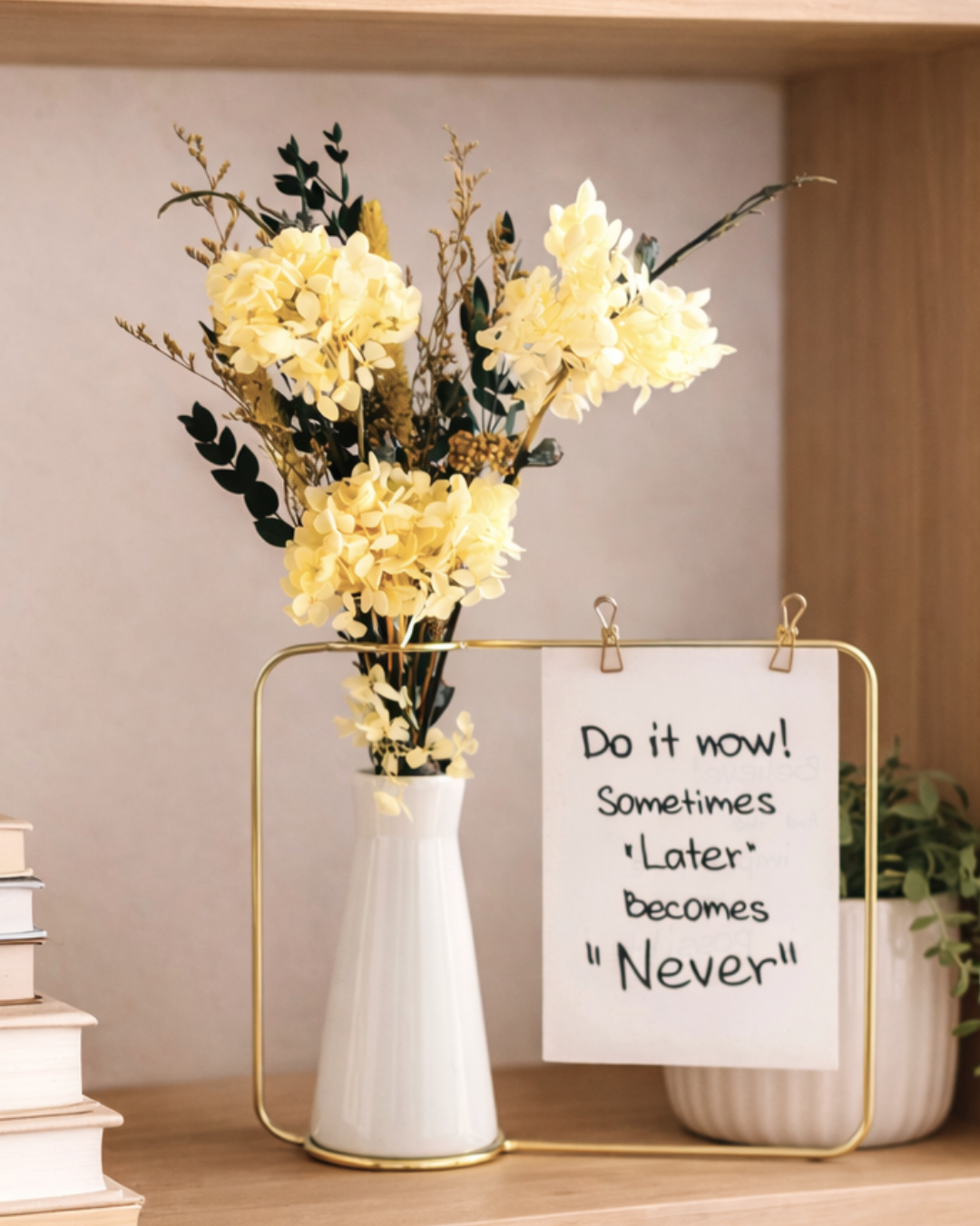 Bouquet of yellow preserved flowers in a white vase with a motivational sign on a shelf. | Fleur Reverie