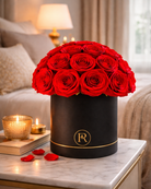 Black box with red roses on a marble surface with candles and books in the background | Fleur Reverie | Austin TX