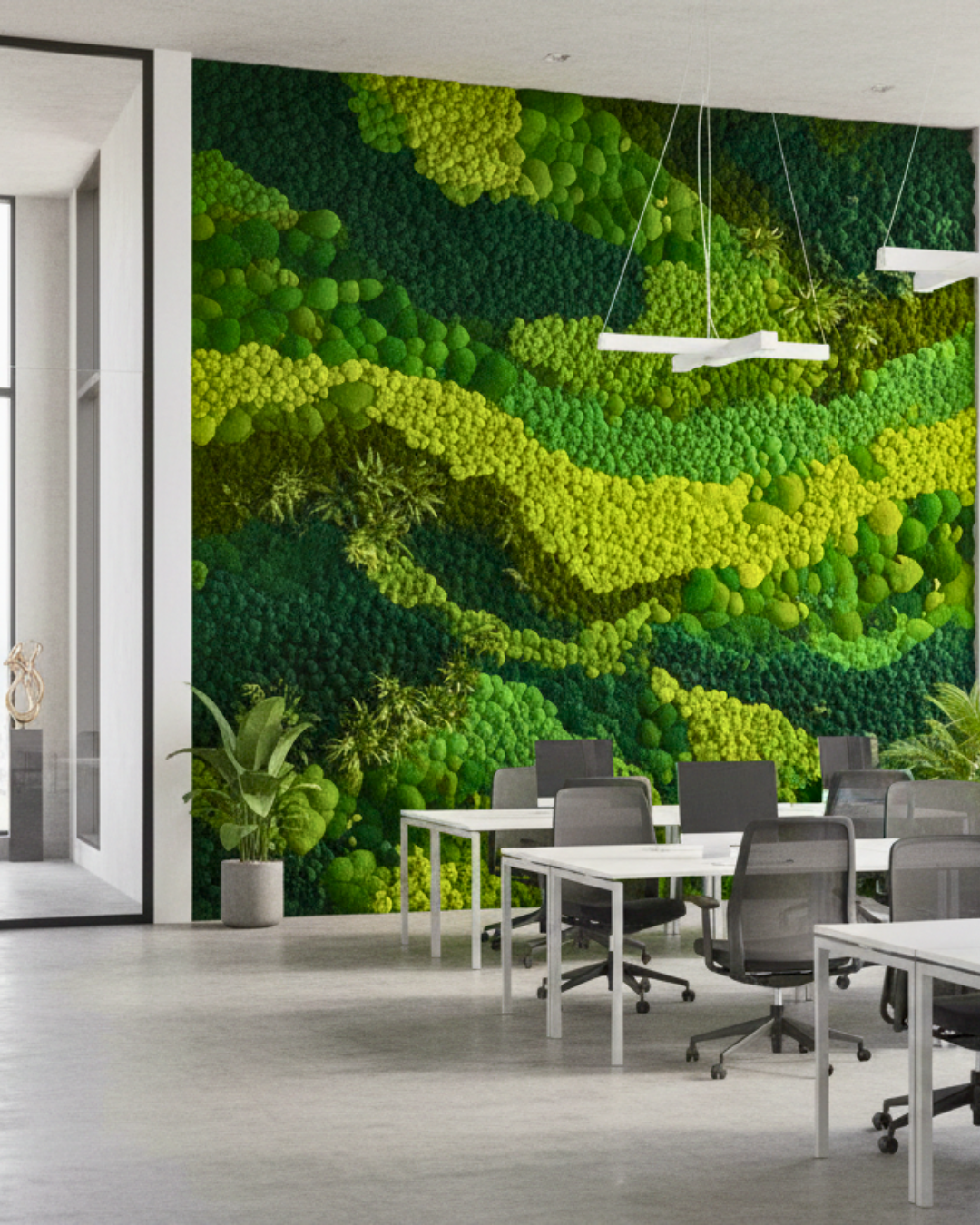 Modern office interior with a large green moss wall in the background.