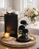 Black roses in a glass dome with 'Fleur Reverie' packaging on a wooden tray | Fleur Reverie | Austin TX