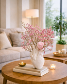 Decorative vase with pink dried flower branches on a wooden coffee table in a living room | Fleur Reverie | Austin TX