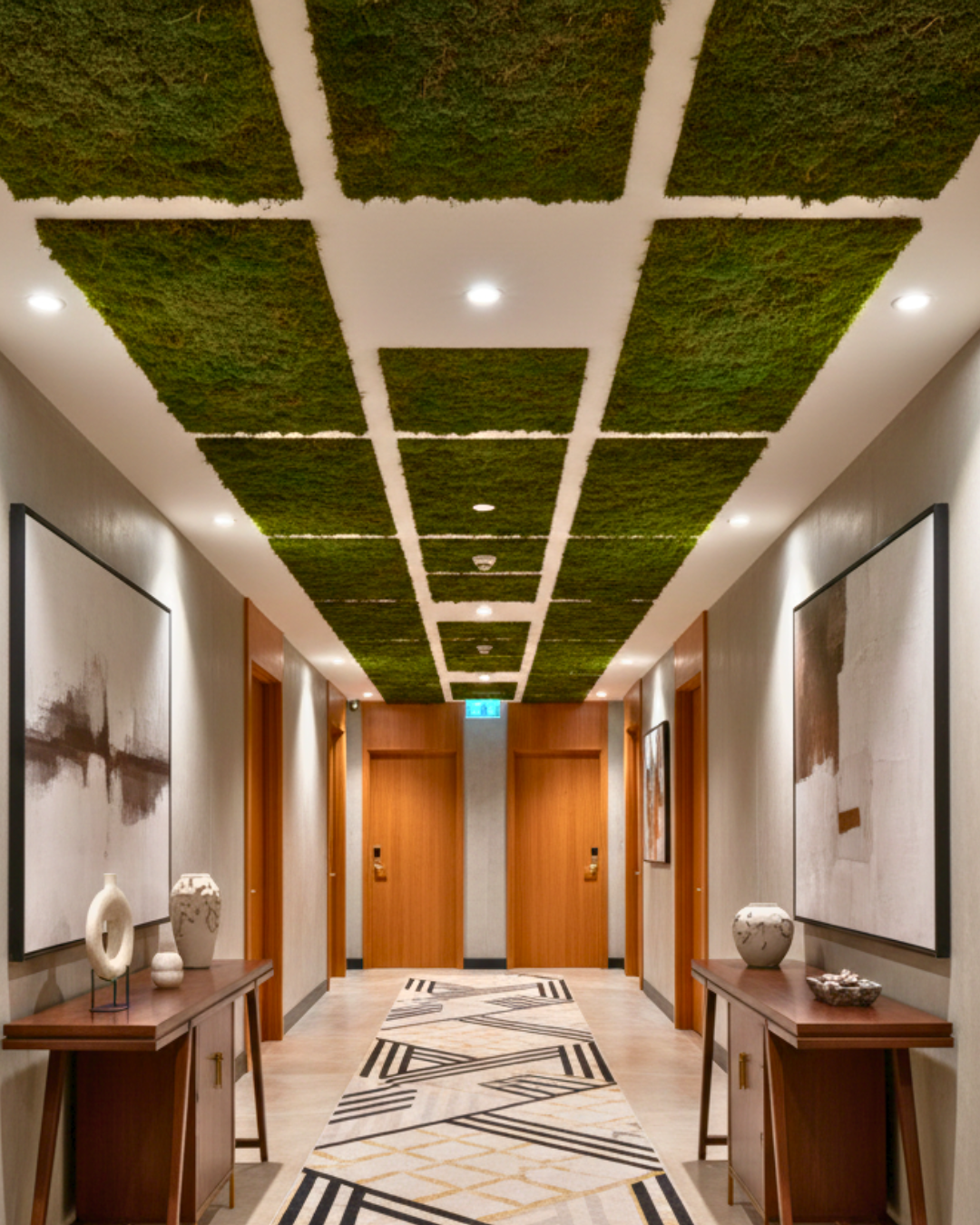 Modern hallway with green preserved moss ceiling panels and wooden furniture | Fleur Reverie