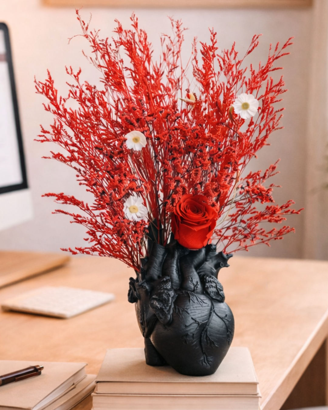 Decorative heart vase with red and white preserved flowers on a desk | Fleur Reverie