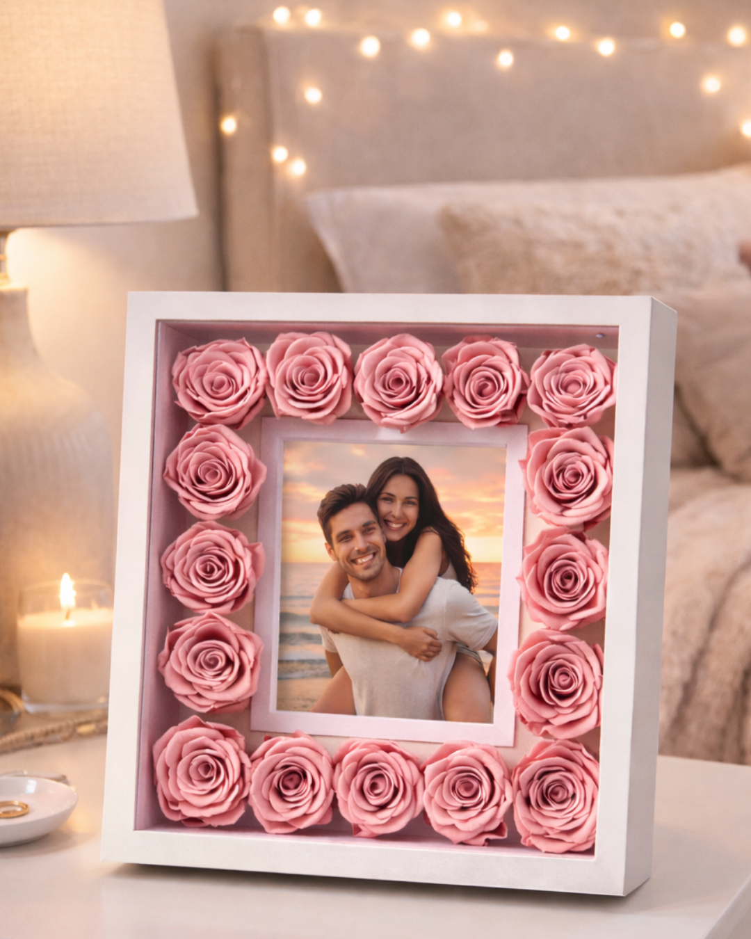 Decorative shadow box with pink preserved roses and a photo of a couple, placed on a table | Fleur Reverie