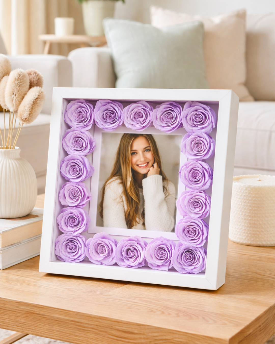 White frame with preserved purple roses holding a photo of a woman on a wooden table | Fleur Reverie