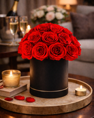 Black box with red preserved roses on a wooden table with candles and books in a cozy room | Fleur Reverie | Austin TX